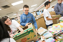 Oswill helped sort children's books in January through Into the Streets, a community service day organized by the university.