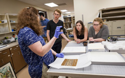 Image of: History professor Ann Nicgorski shows some examples of ancient textile remnants to her LARC students at the Hallie Ford Museum of Art. 