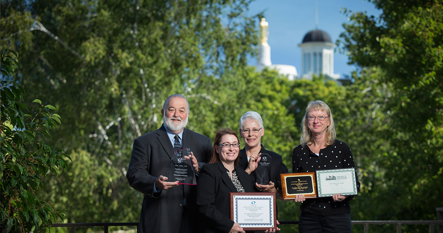 Career Services staff members showcase their awards. 