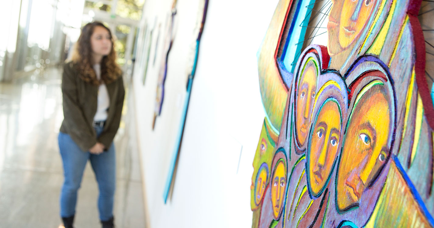 Students viewing Betty LaDuke painting