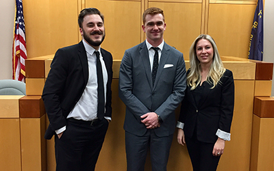 Nat Levy (L), runner-up of the Don Turner Moot Court Competition, stands next to the winners, Conor McCahill and Autumn Mills.