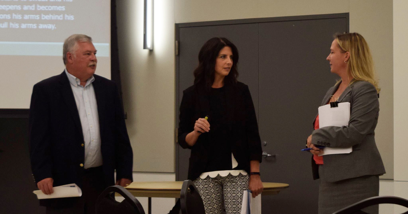 Erin Greenawald JD'98 (middle), domestic violence resource prosecutor for Oregon Department of Justice, conducts training on 