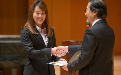 ASP student receives certificate at closing ceremony.