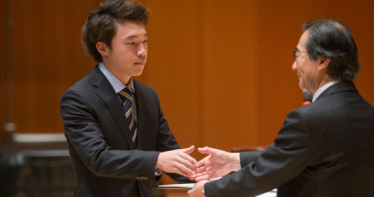 American Studies Program student receives a certificate of completion at the program’s closing ceremony.