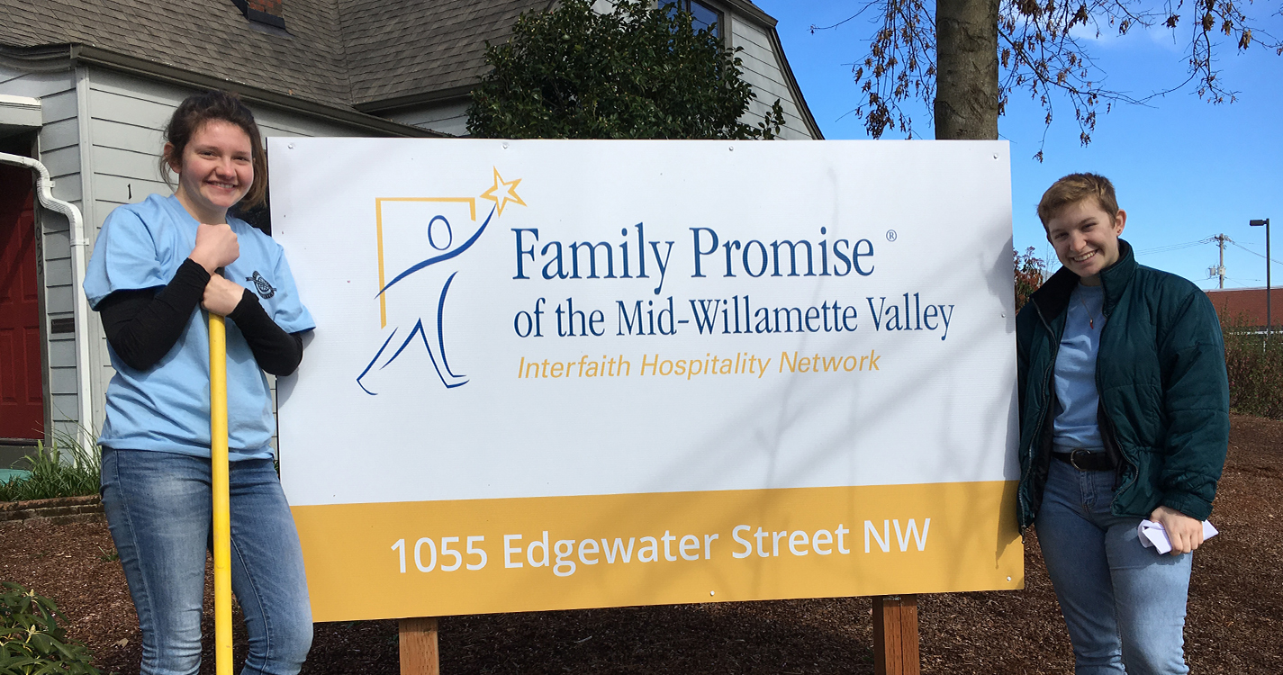 Students pose by Family Promise sign where the volunteered on Willamette’s Global Day of Service.