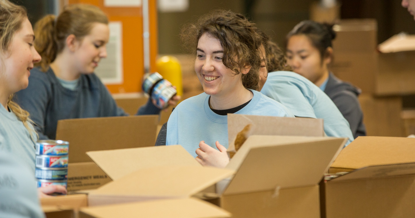 Students pack boxes as part of Willamette’s Global Day of Service.