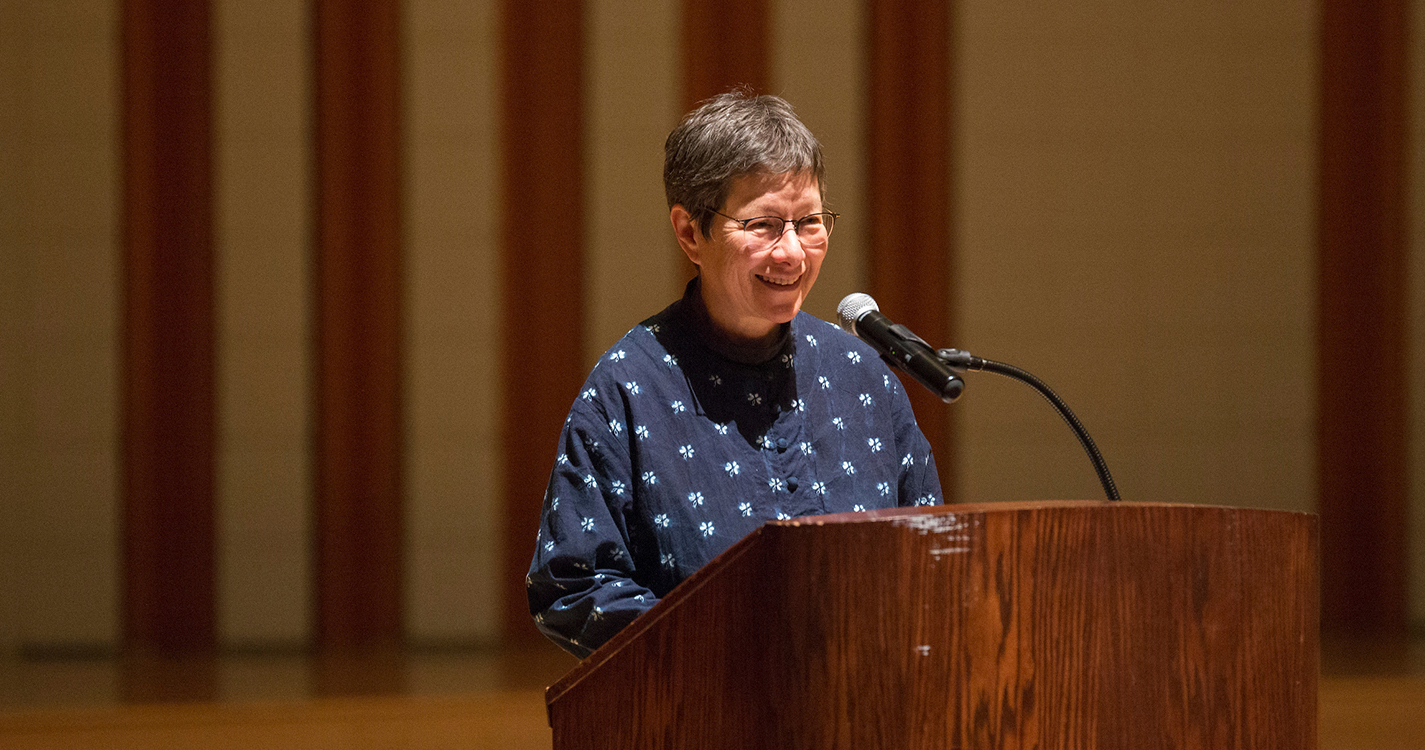 Anna Tsing, a professor at UC Santa Cruz, speaks from a podium in Hudson Hall