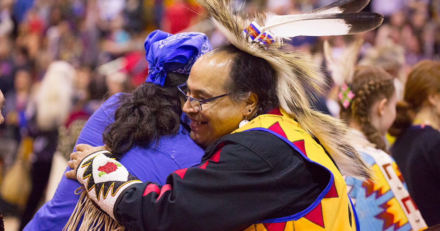 Two people hug at the Social Pow wow.