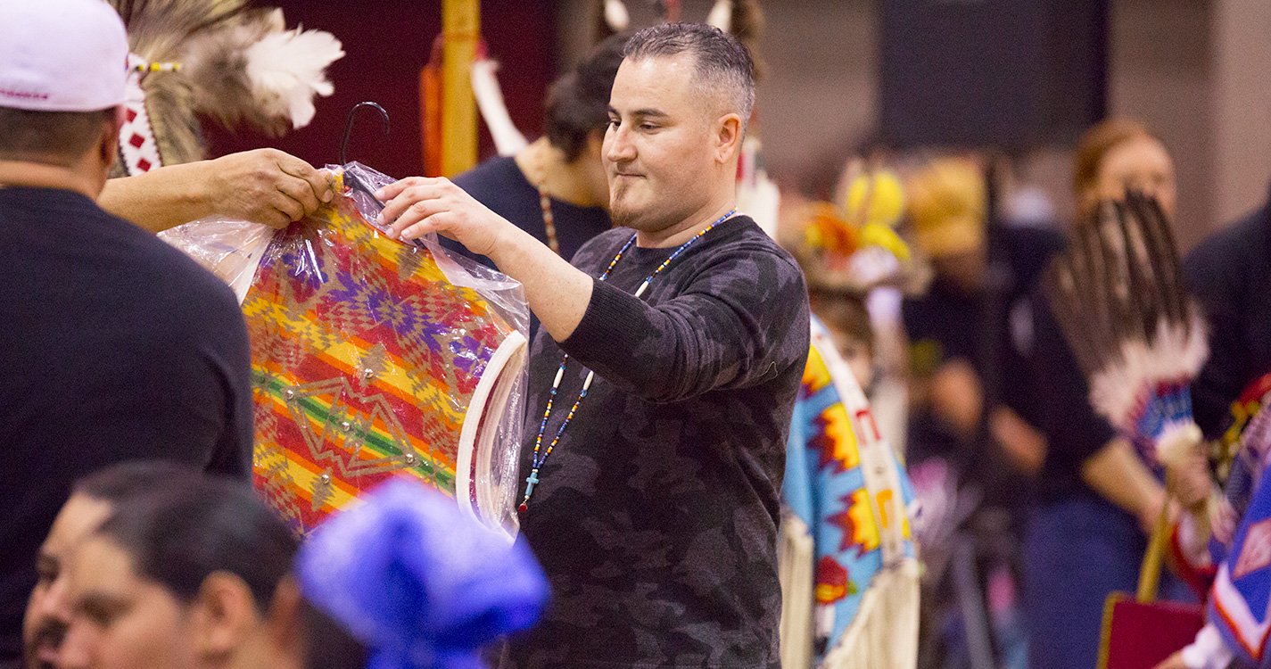 A child rides on another child’s back at the Social Pow wow.