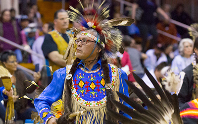 Man dressed in regalia at pow wow