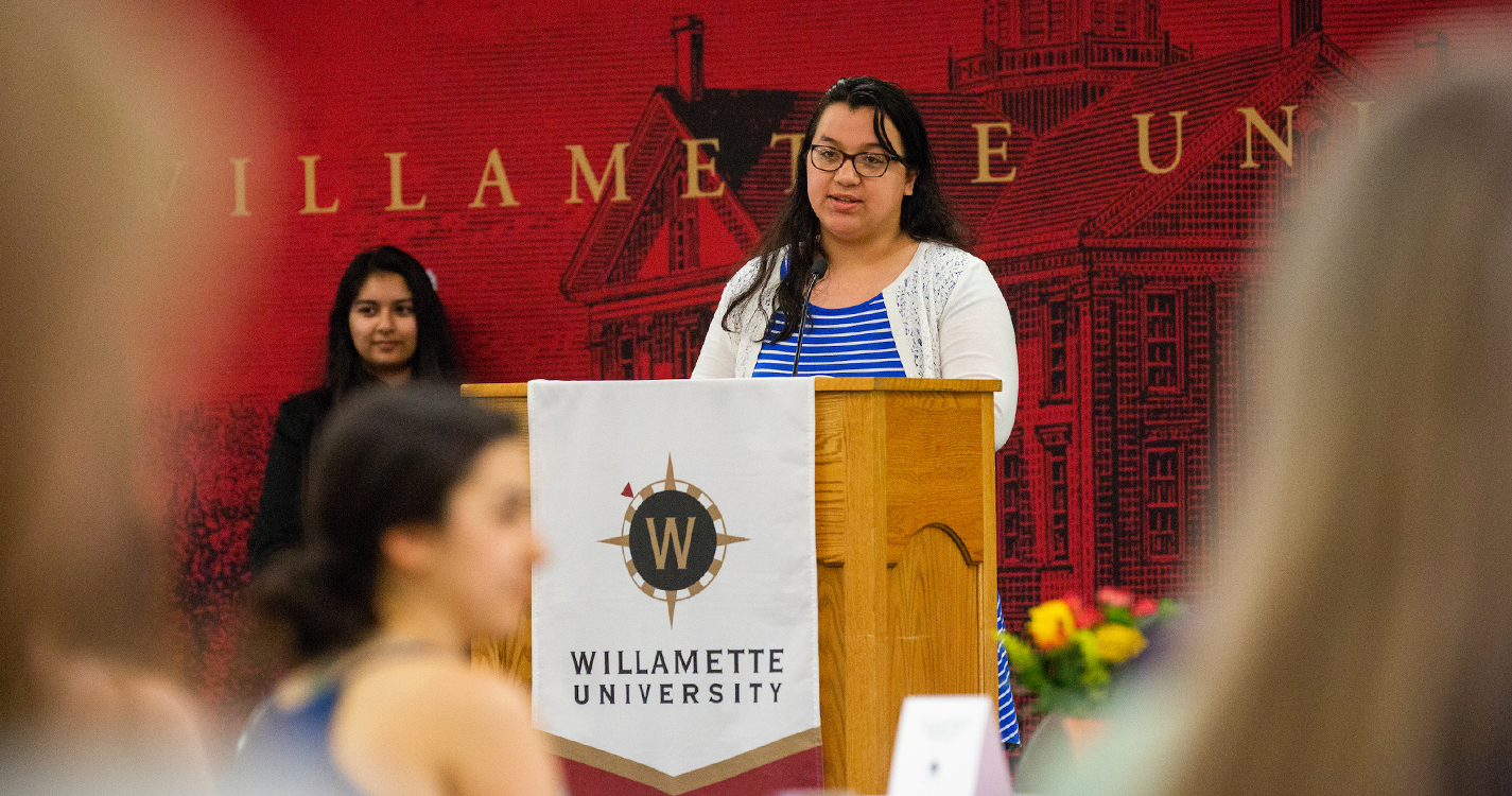 a person speaks from a podium presenting an award