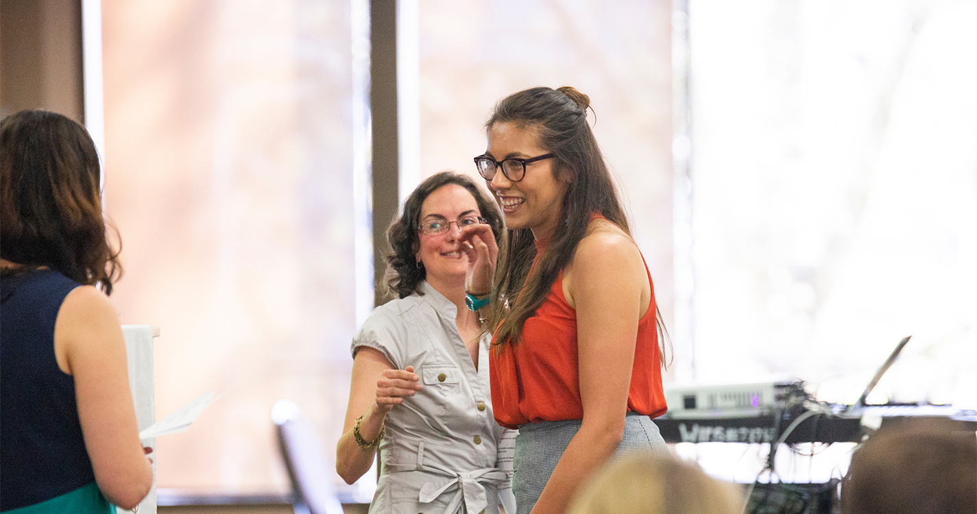 student smiles after receiving and award