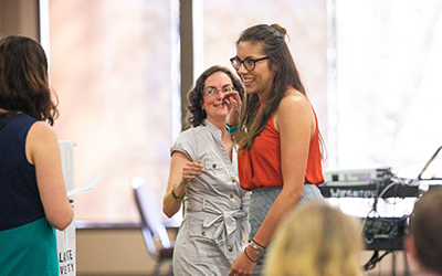 student smiles after receiving an award