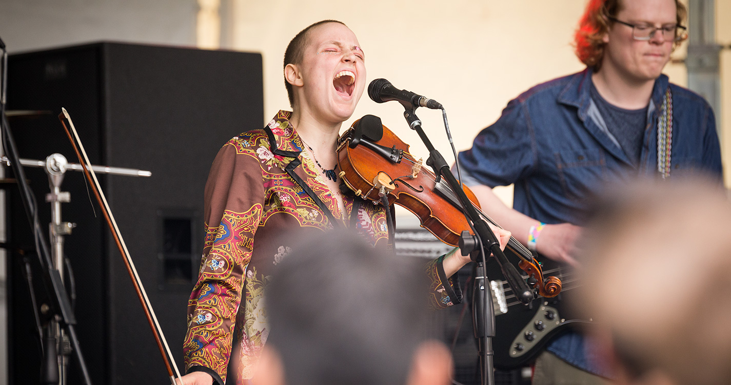 A violinist with eyes closed sings with passion.