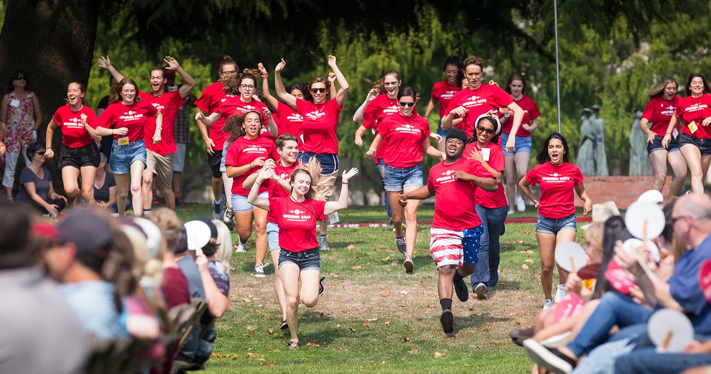 Opening Days leaders rush the Quad during the kick-off event for new students and their families.