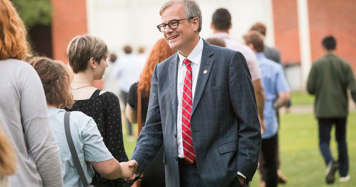 President Steve Thorsett shakes the hands of new students during the Matriculation Ceremony.