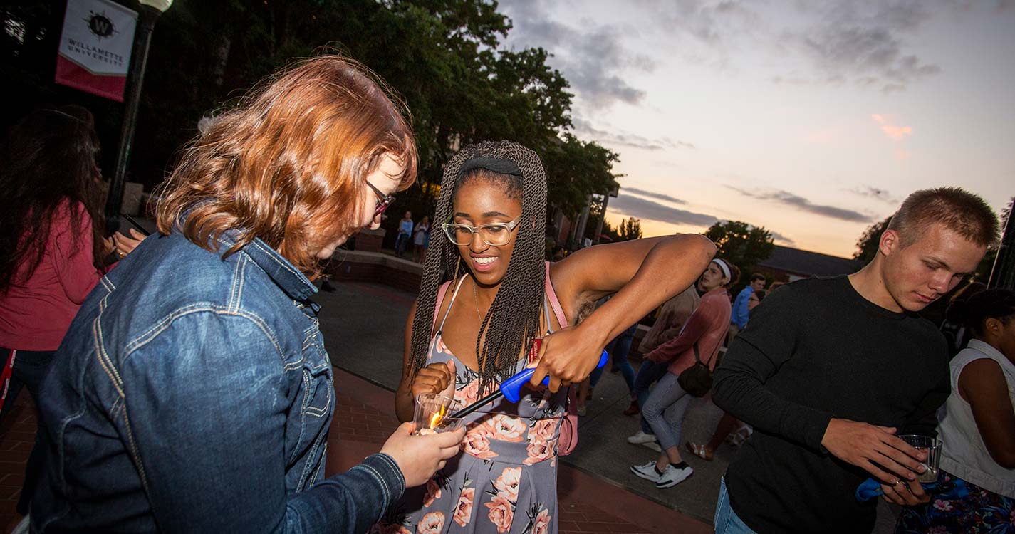 ASWU President Akerah Mackey ’19 lights new students’ candles during the Matriculation Ceremony.