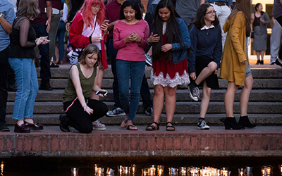 A new student releases her candle to the Mill Stream during Matriculation.