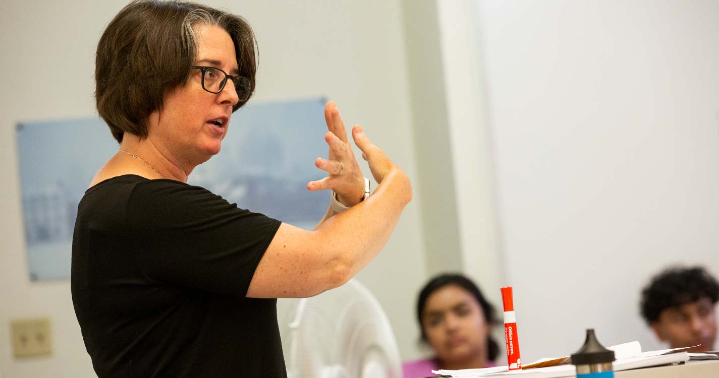 A professor stands before Willamette Academy students teaching