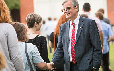 President Thorsett shakes the hand of a new student