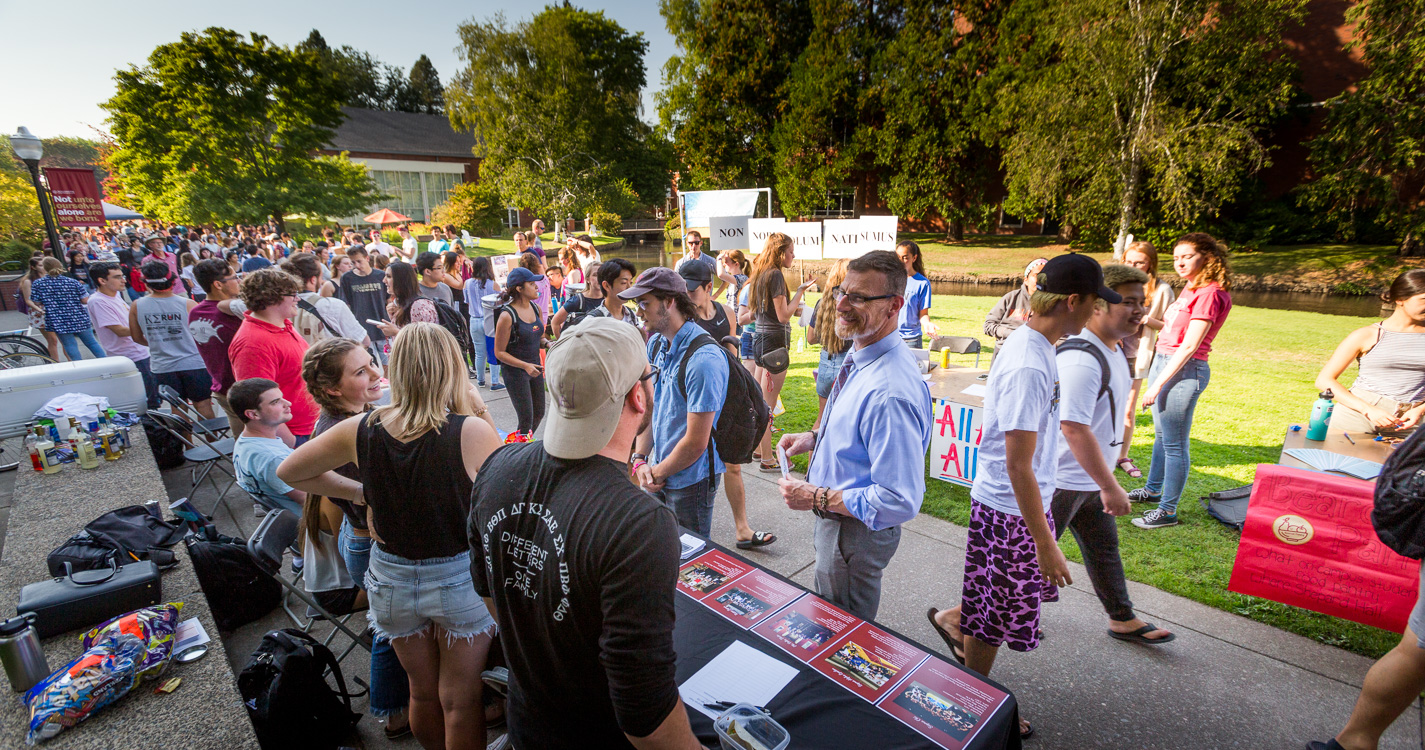 Bearcats pack a sidewalk lined with expo tables 