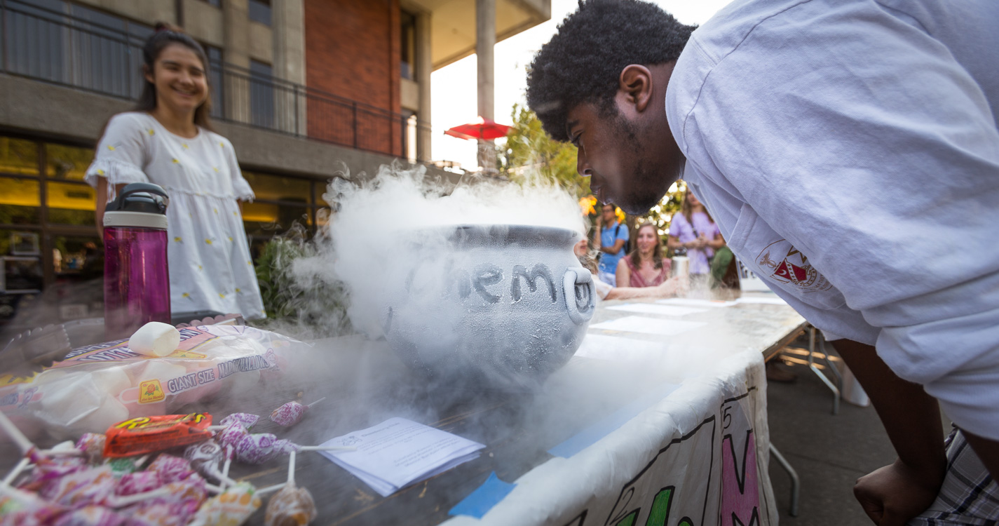 A student blows on a chemistry experiment