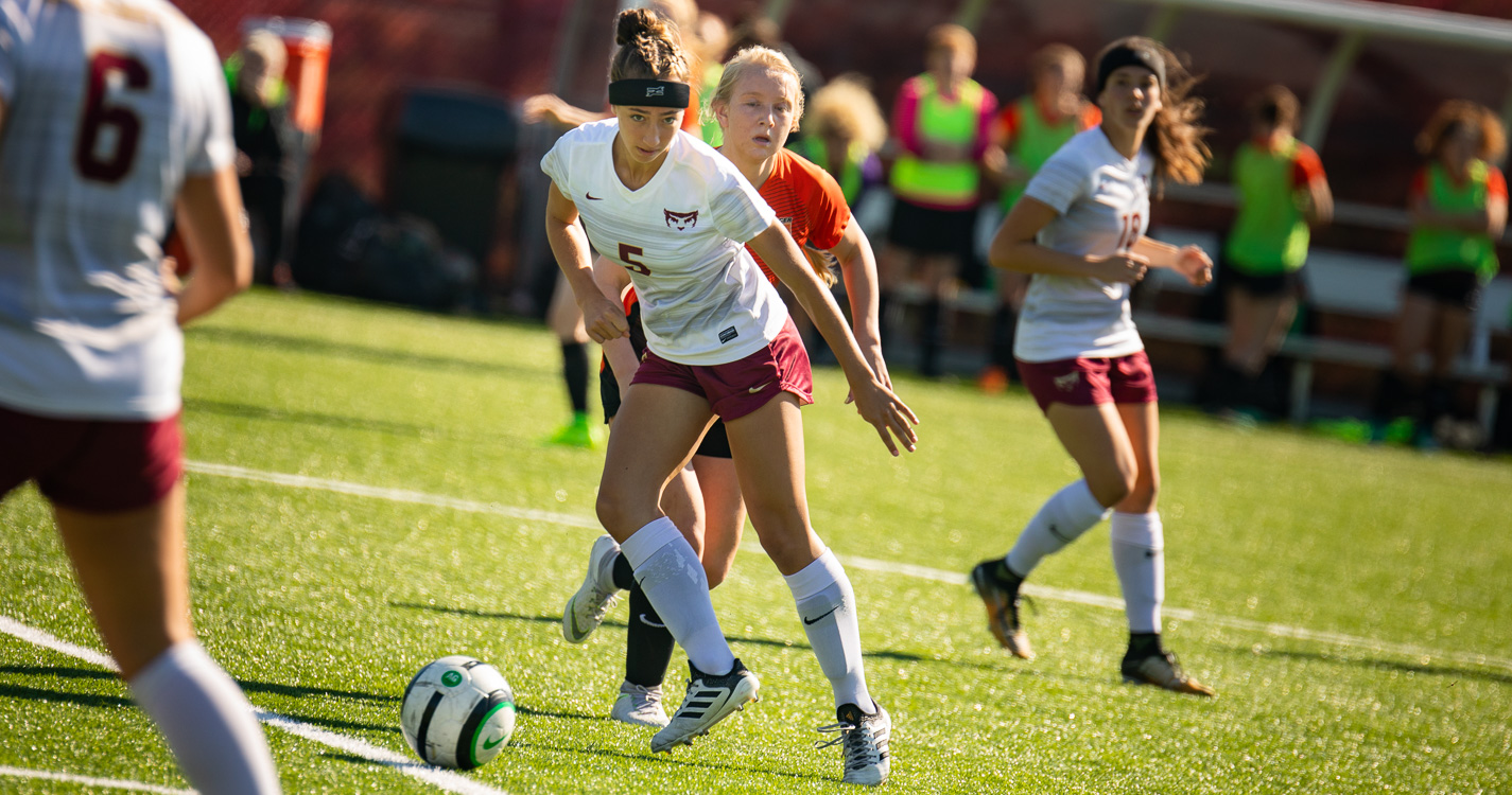 A soccer player kicks the ball