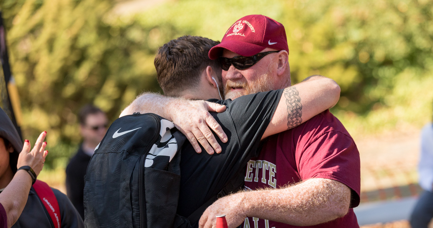 A student and parent hug