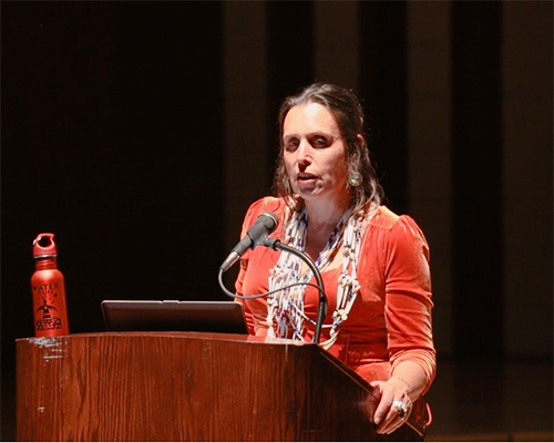 Woman speaks at podium