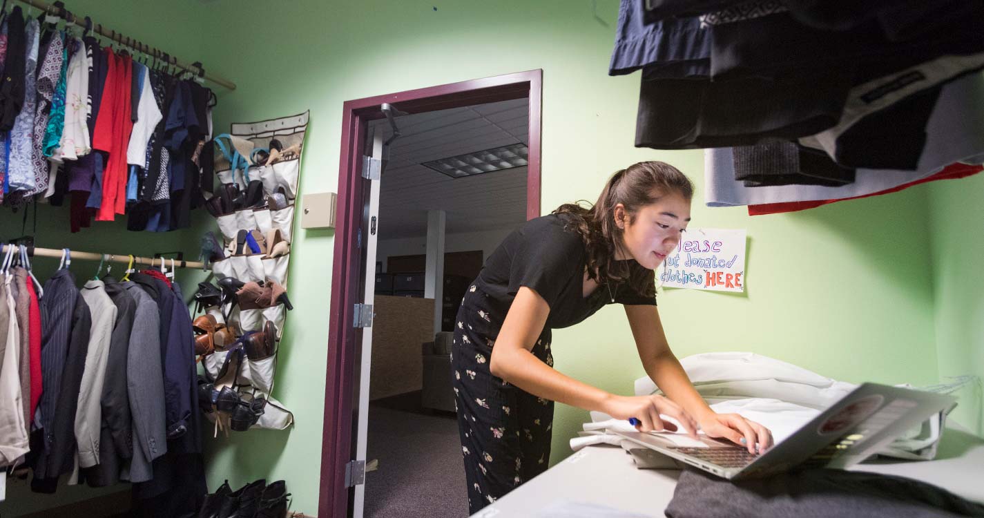 Michelle Hicks ’20, co-coordinator of the Clothing Share, checks the inventory. 