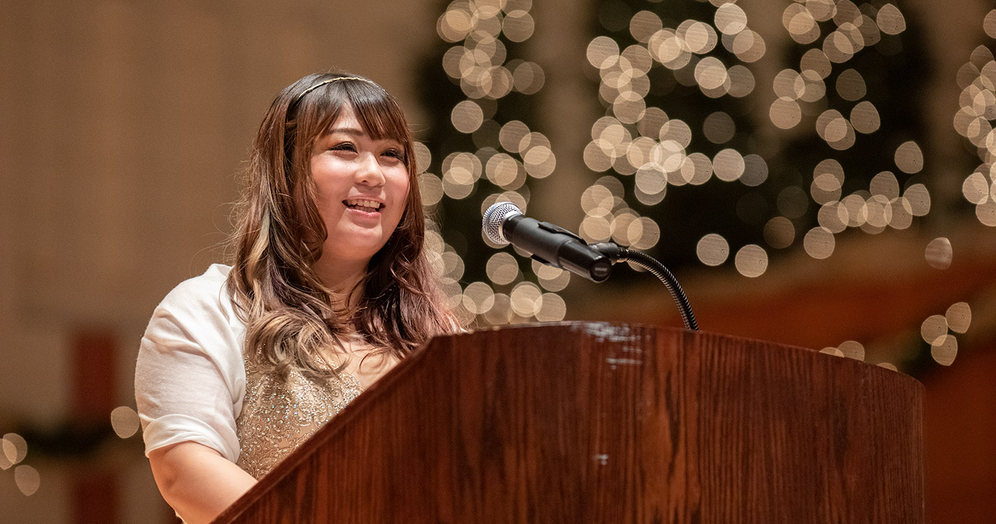 Mai Hiwatashi speaks at podium