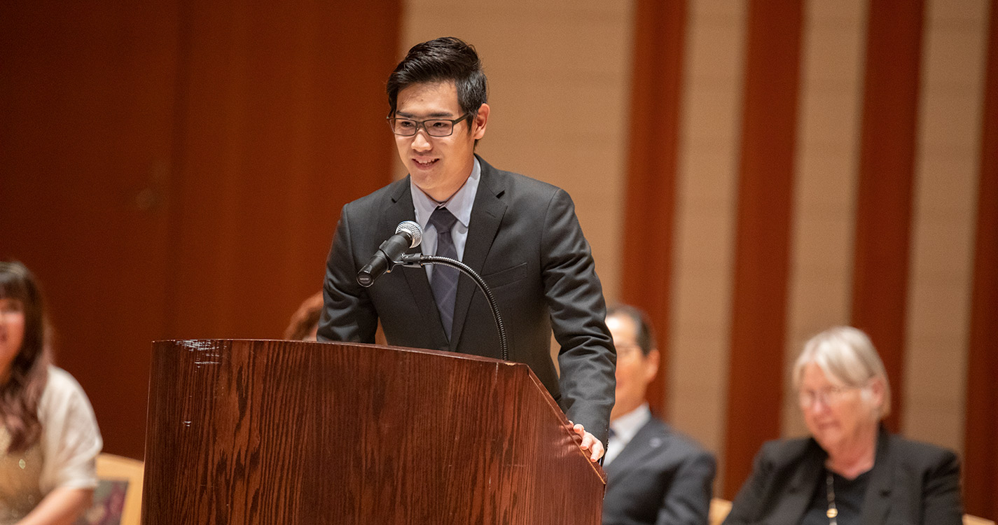 Taiga Hakoyama speaks at podium