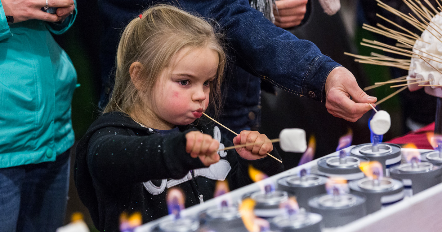 Girl enjoys a s'more. 