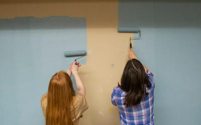 Students paint wall for Into the Streets