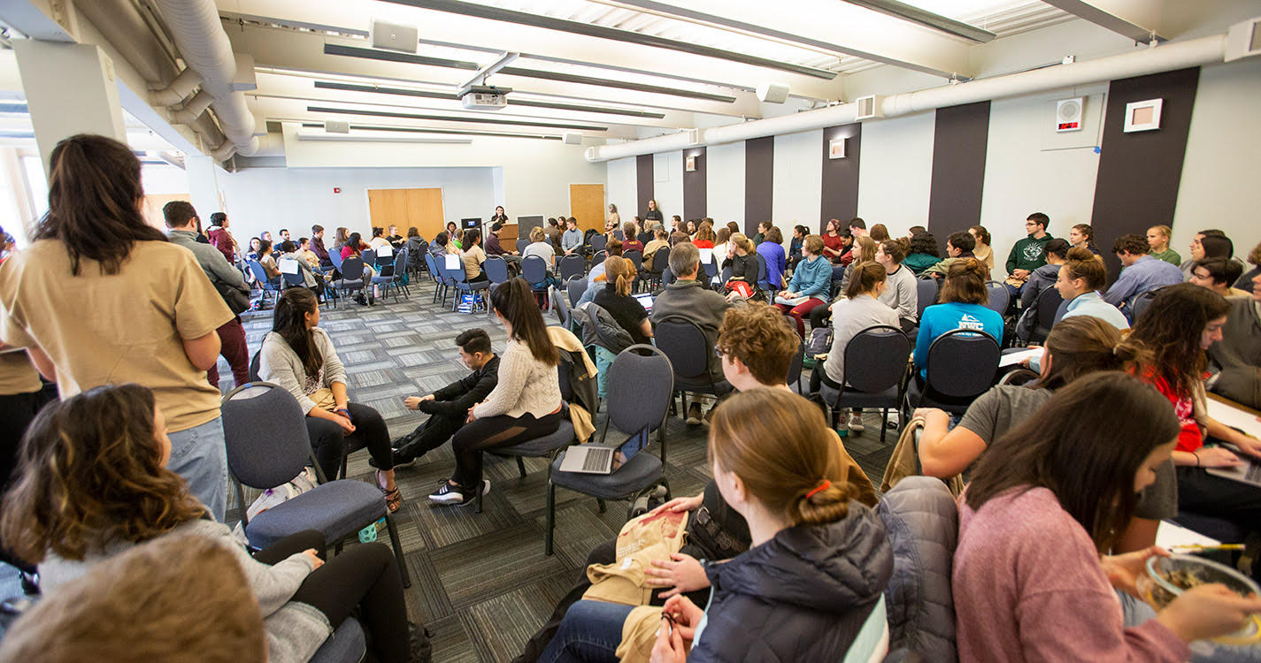 Large group of students listen to speakers 