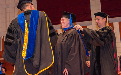 graduate gets hooded