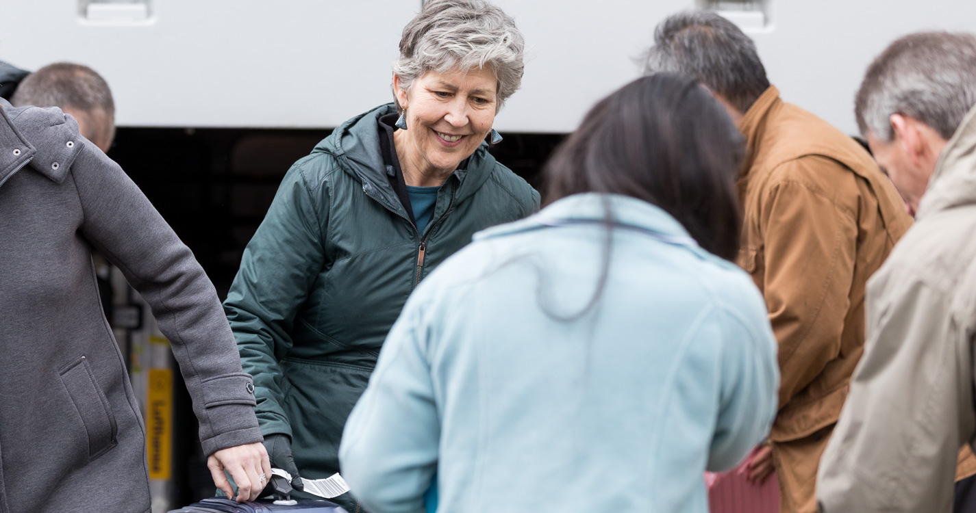 Chaplain Karen Wood assists with baggage