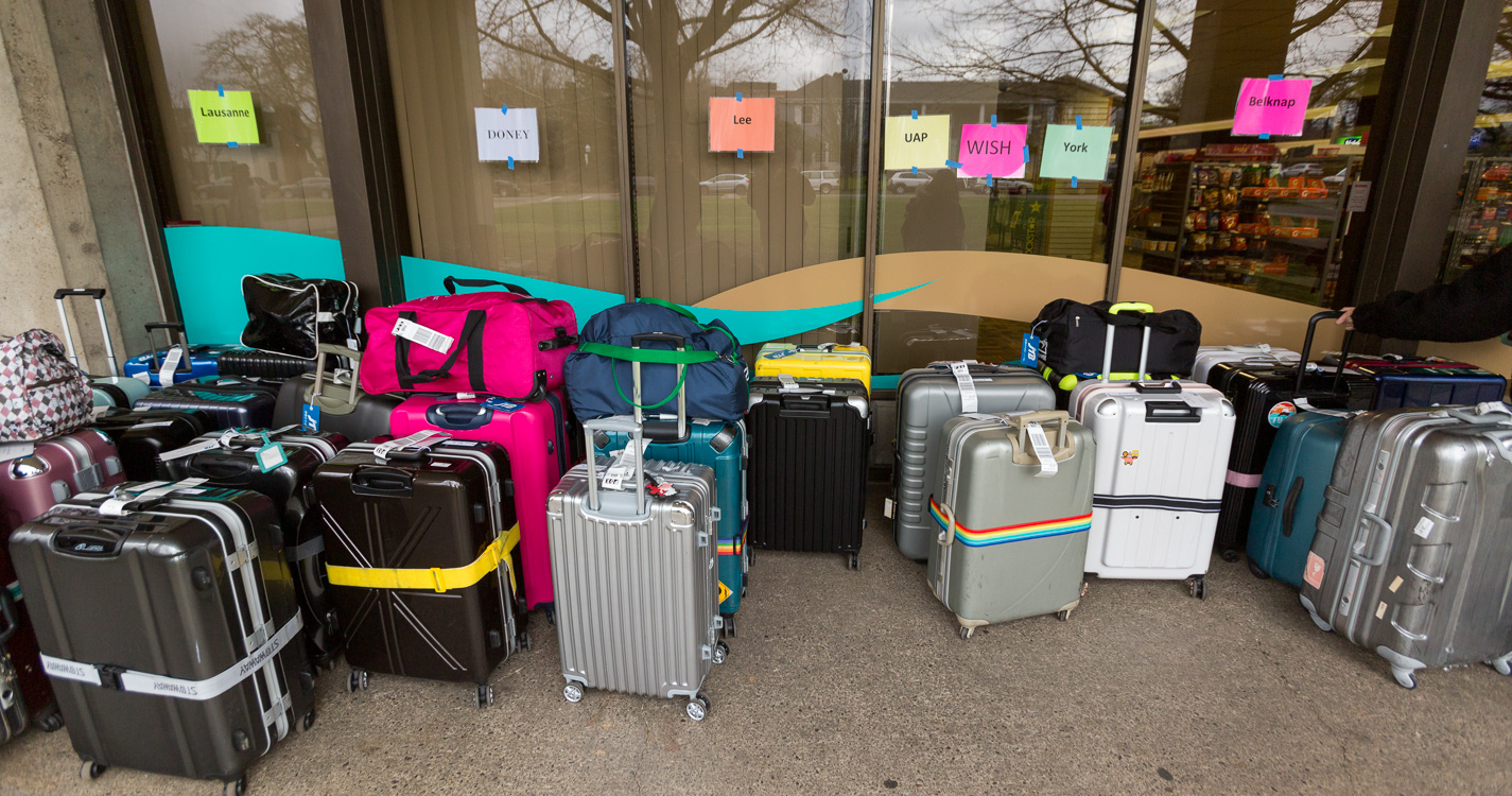 Bags in lines with color coordinated labels for each residence hall