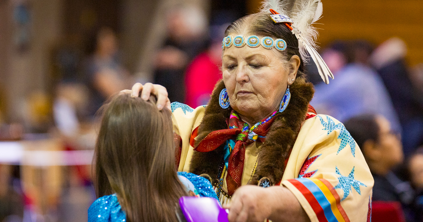 an elder with hand on a child's head