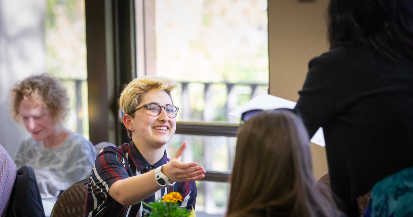 Smiling student receives award certificate