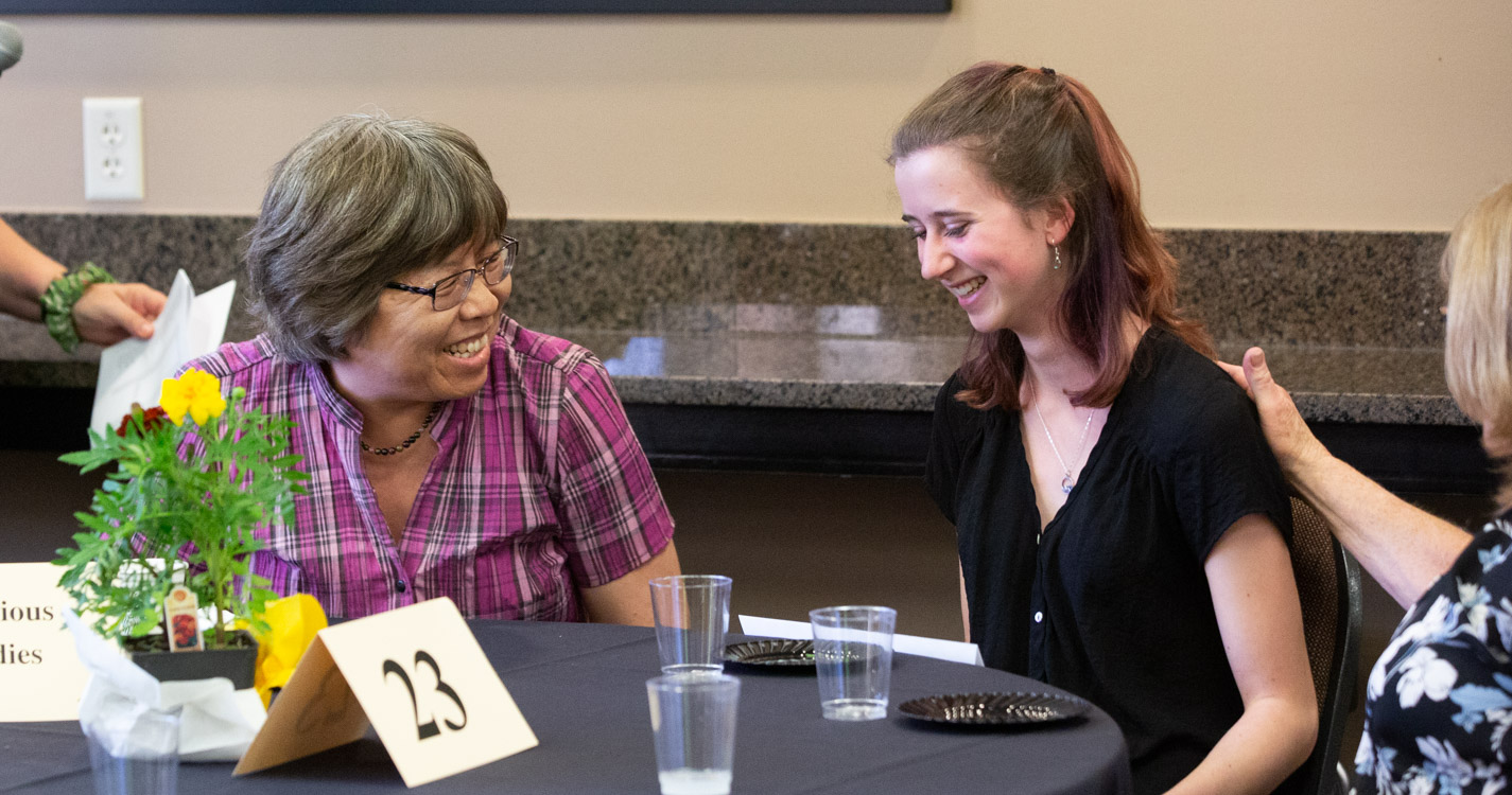 Student smiles after receiving award