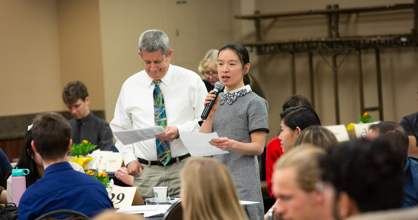 Professor reads into a microphone