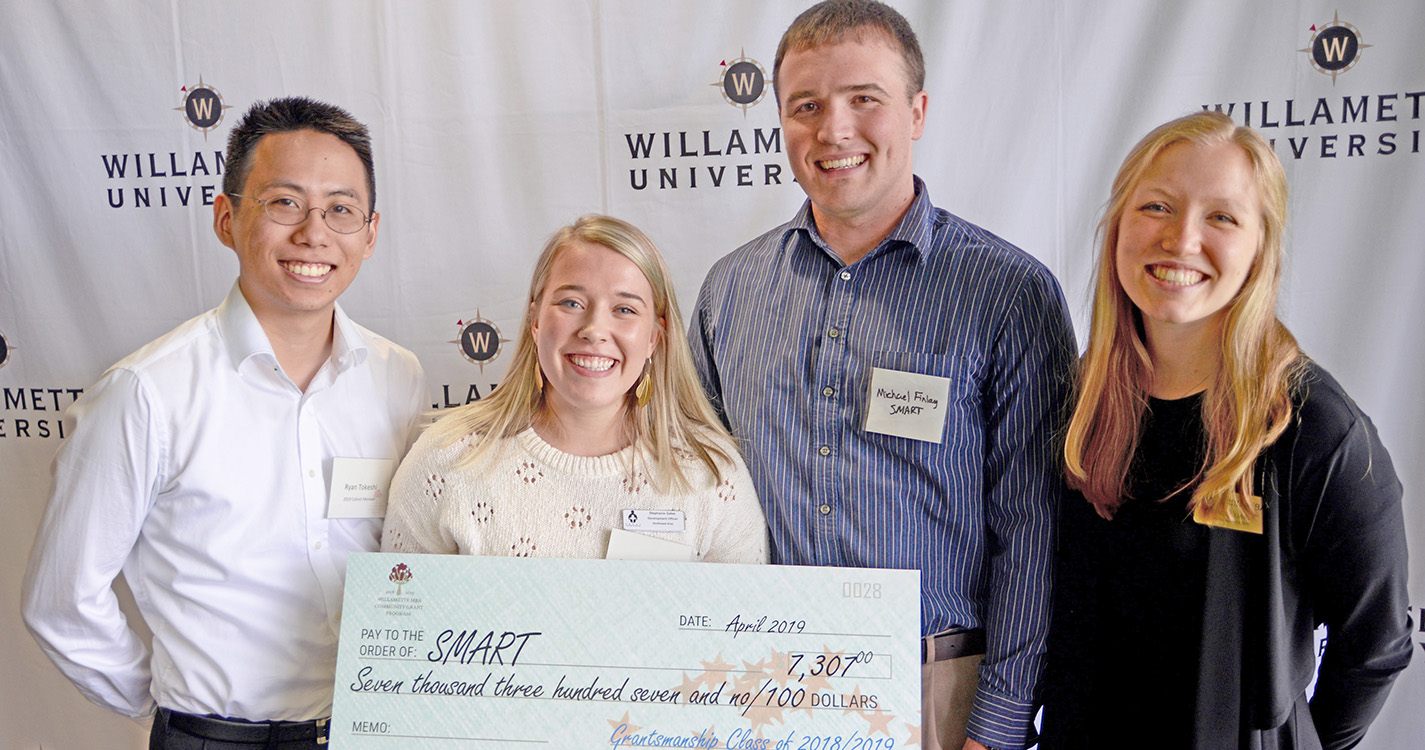 students present check to a grant recipient