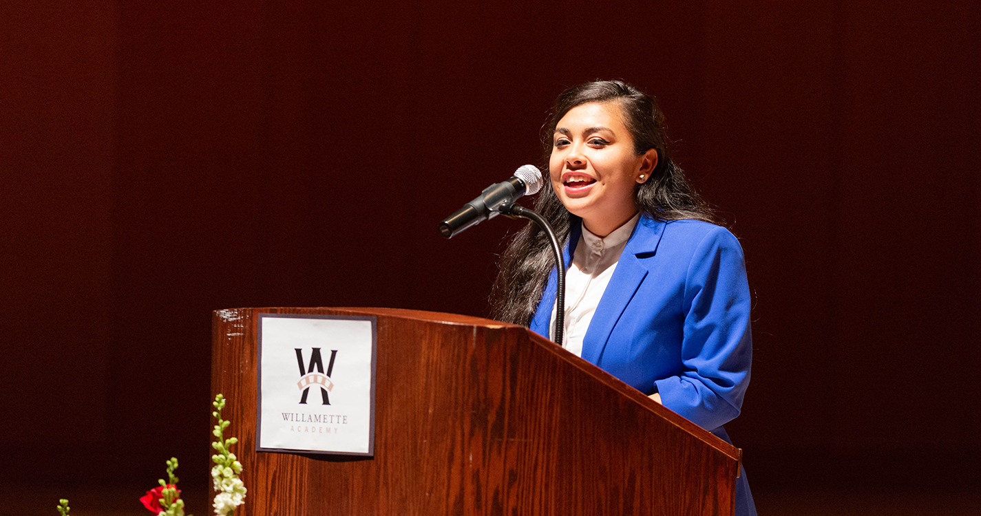 Speaker at a podium delivers an address