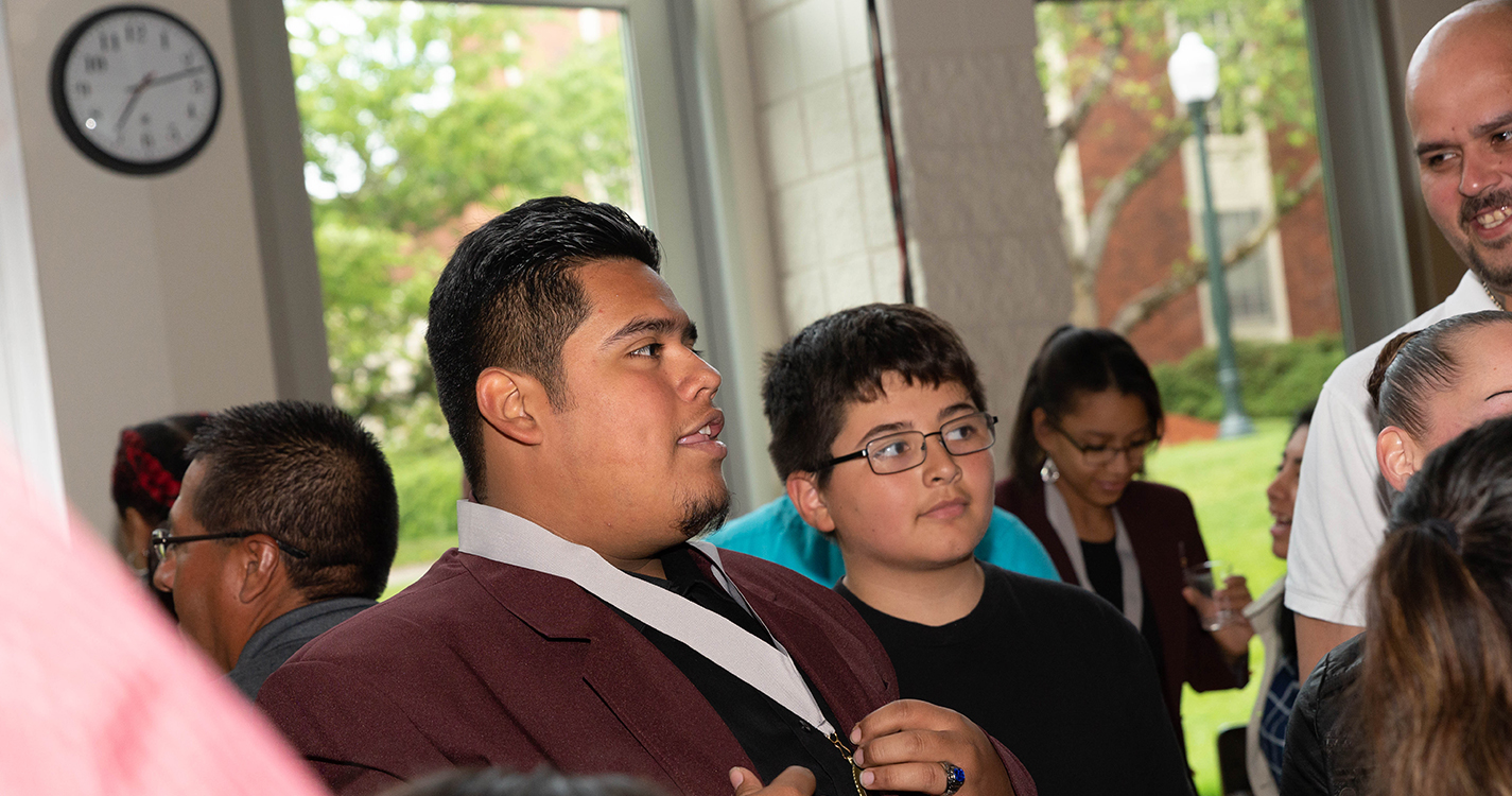 A graduate speaks to guests at the reception