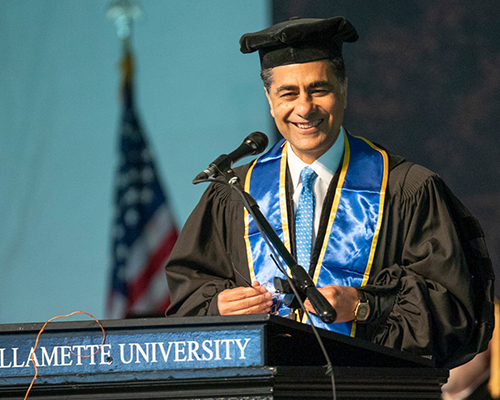 Punit Renjen speaks from a podium