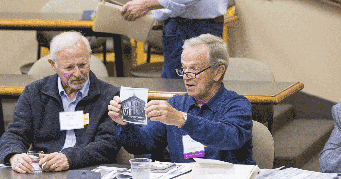 College of law alumnus shows off an archival picture of the law school