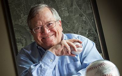 Dennis Koho holds a baseball