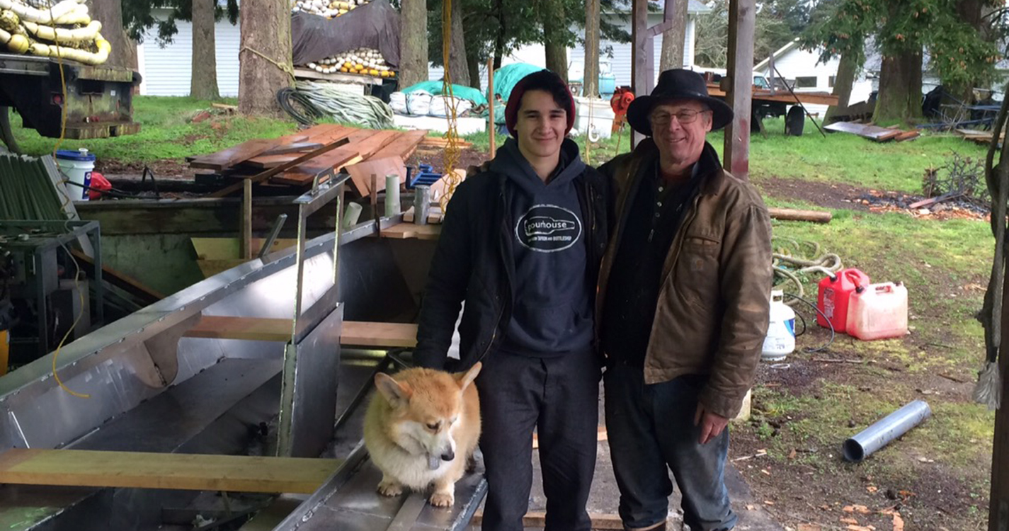 Student poses with father and dog