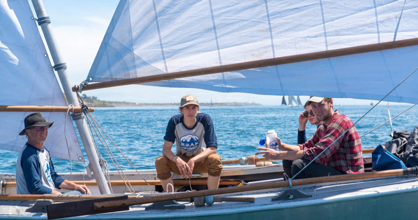 Student's team sitting on a boat during the first Race to Alaska attempt in 2017. 